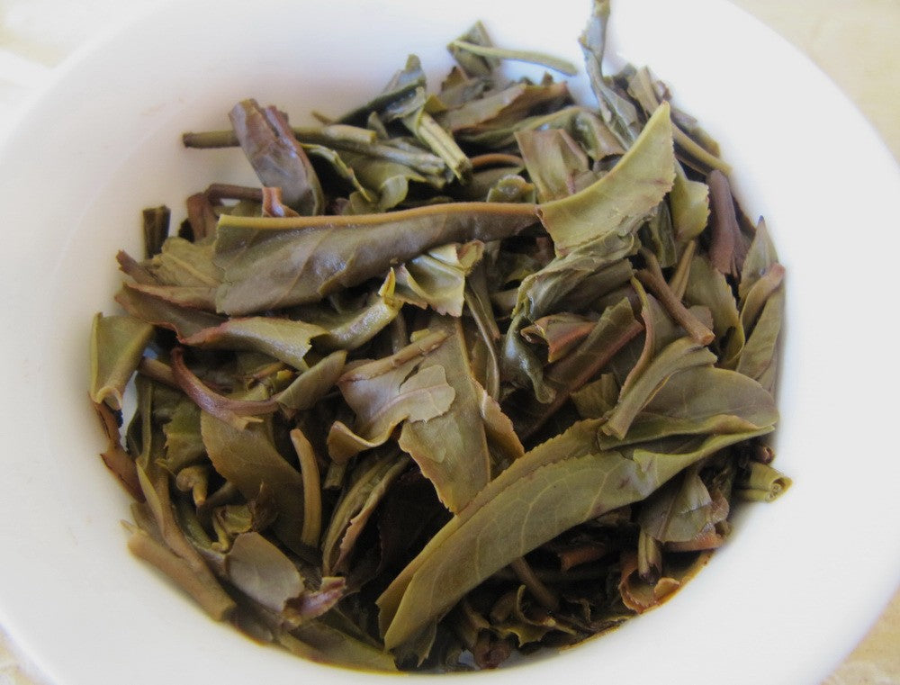 Feuilles infusées - Puer Sheng ManZhuan 250g [photo: Cream of Banna]